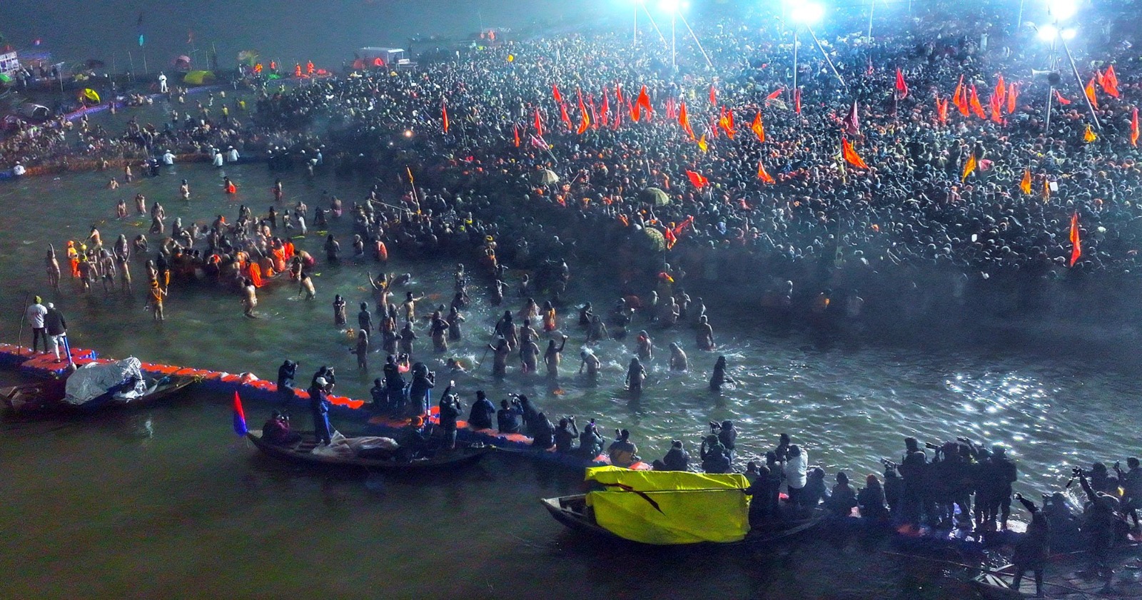 Thousands of devotees immersed in the sacred waters of the Triveni Sangam, performing rituals during the First Amrit Snan of Mahakumbh 2025.