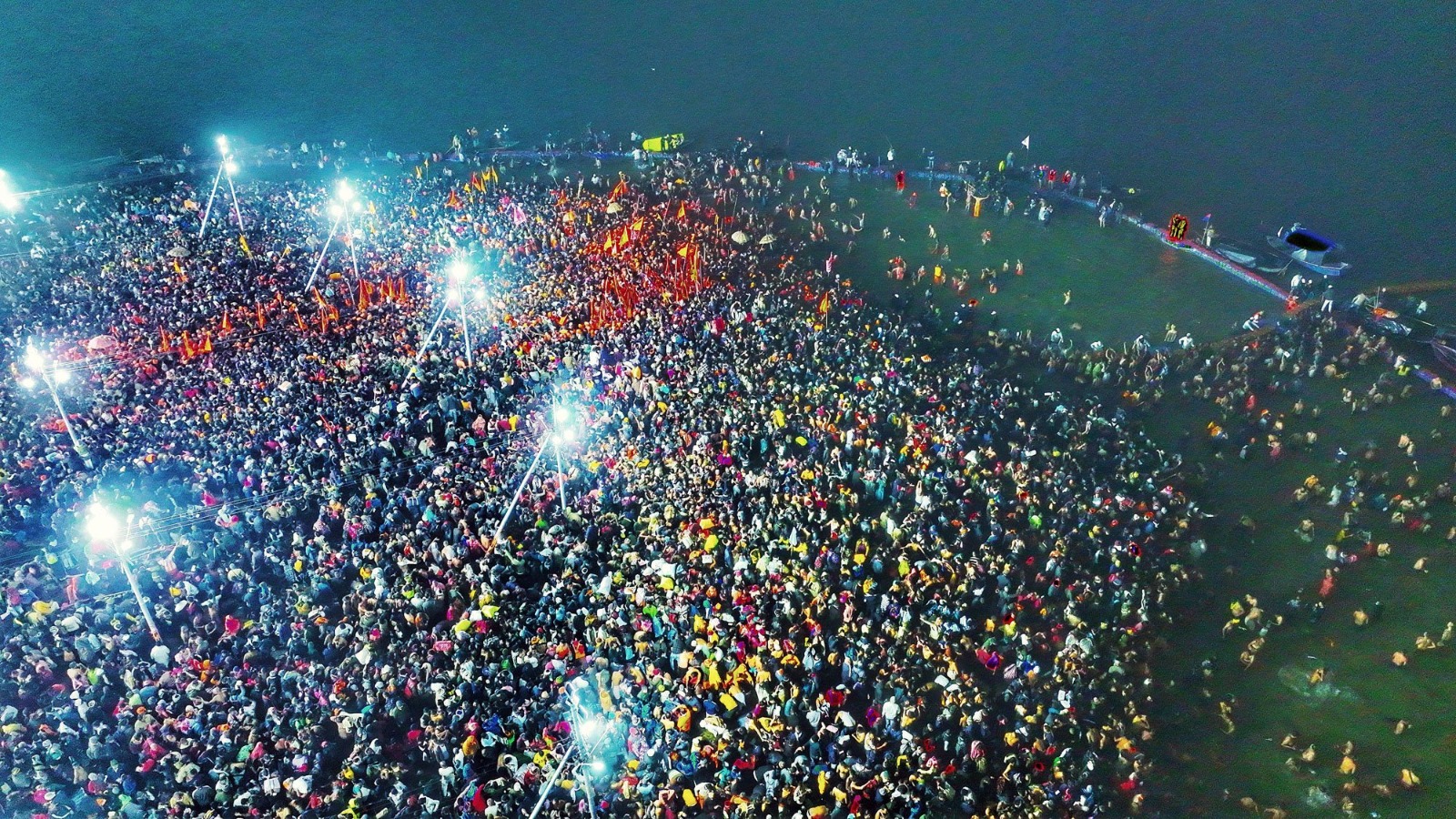 Thousands of devotees immersed in the sacred waters of the Triveni Sangam, performing rituals during the First Amrit Snan of Mahakumbh 2025.
