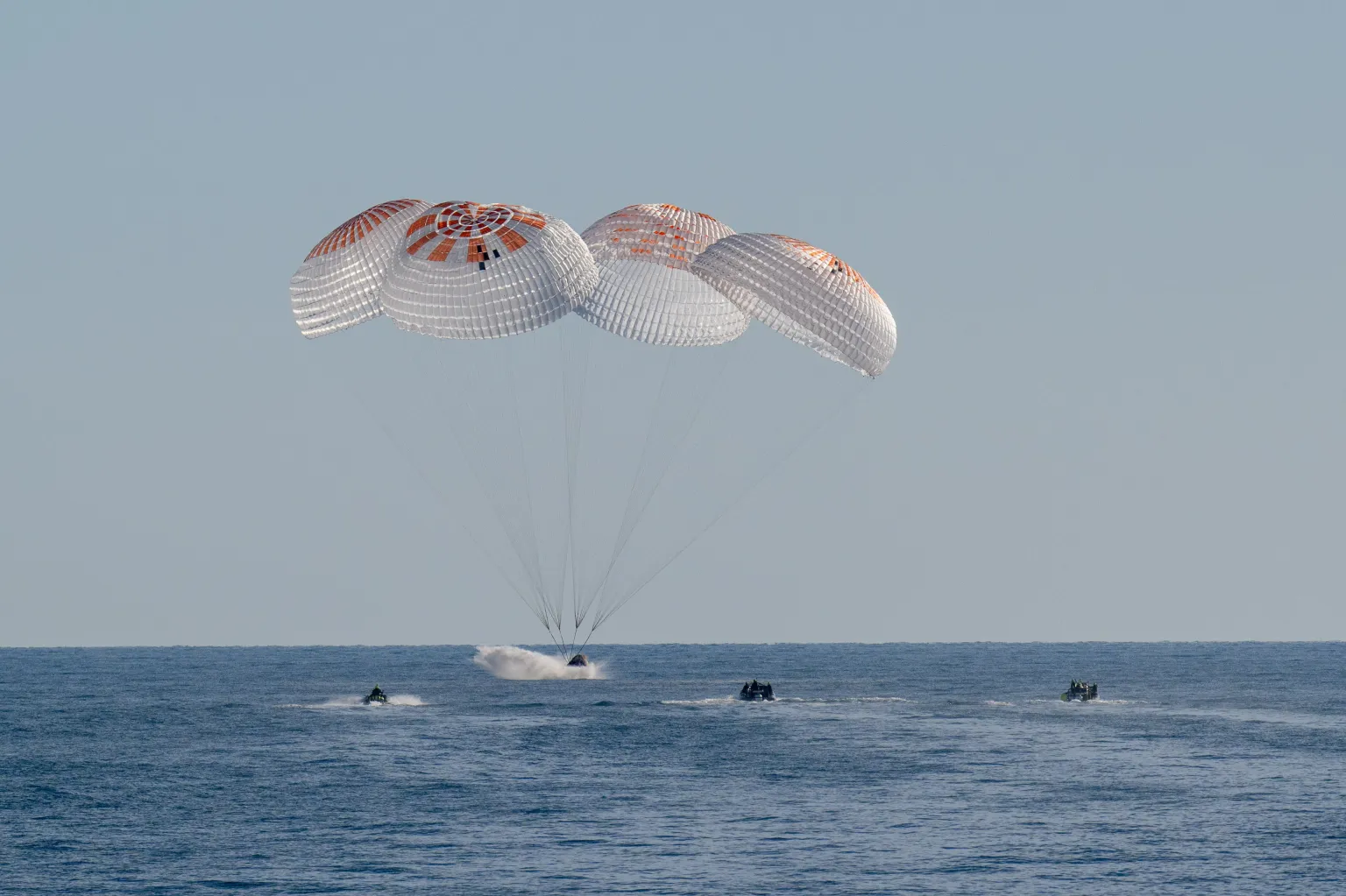NASA astronauts Nick Hague, Suni Williams, Butch Wilmore, and Roscosmos cosmonaut Aleksandr Gorbunov land in a SpaceX Dragon spacecraft in the water off the coast of Tallahassee, Florida on March 18, 2025. Hague, Gorbunov, Williams, and Wilmore returned from a long-duration science expedition aboard the International Space Station. Credit: NASA/Keegan Barber